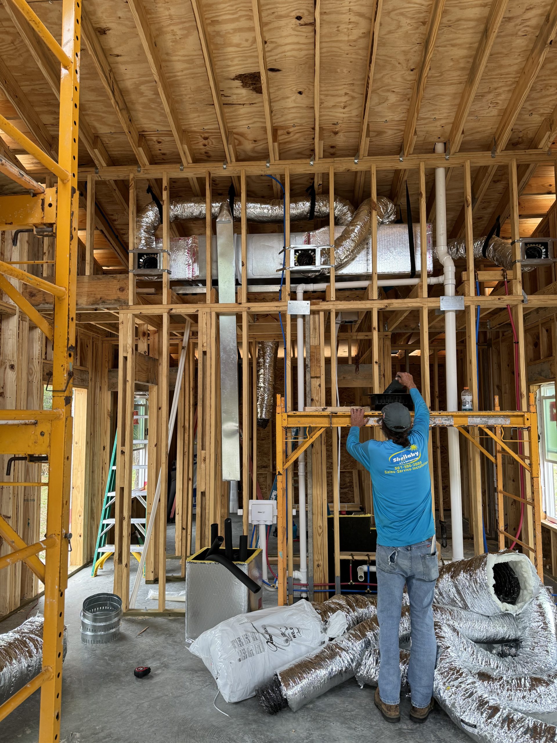 Shellaby technician installing ductwork in a new construction home